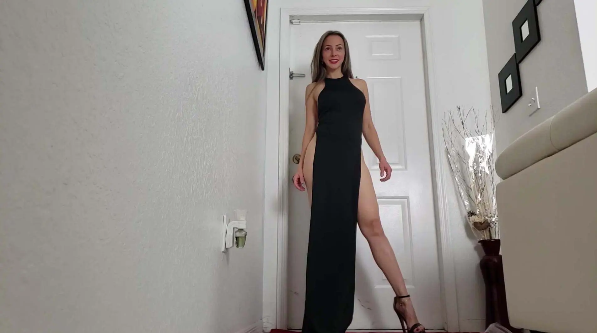Posing in black high heels and long dress with high slit legs picture photo