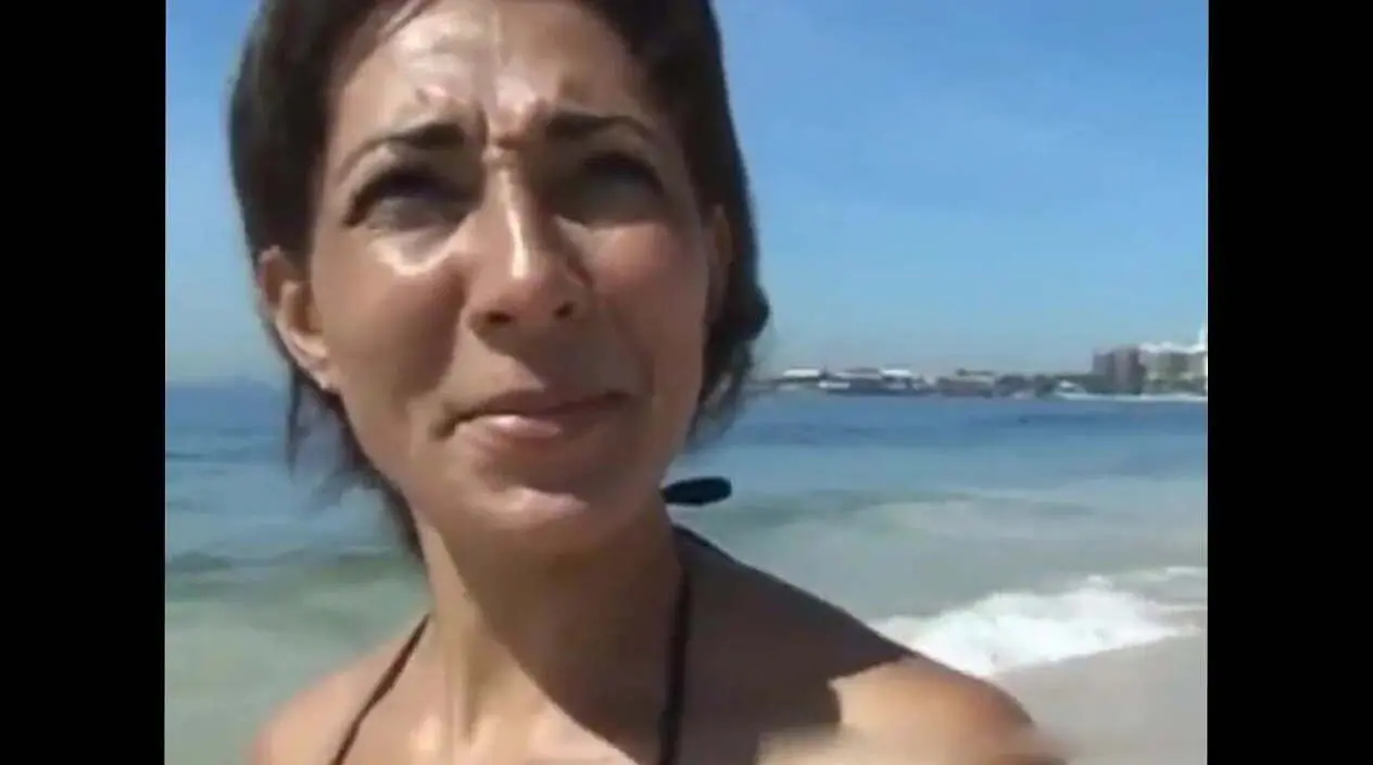 Tanned cougar was picked up on a public beach for kinky sex and a facial image